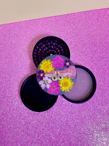 grinder covered in real flowers and a butterfly