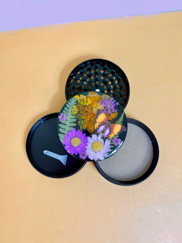 flower grinder with real flowers and a butterfly