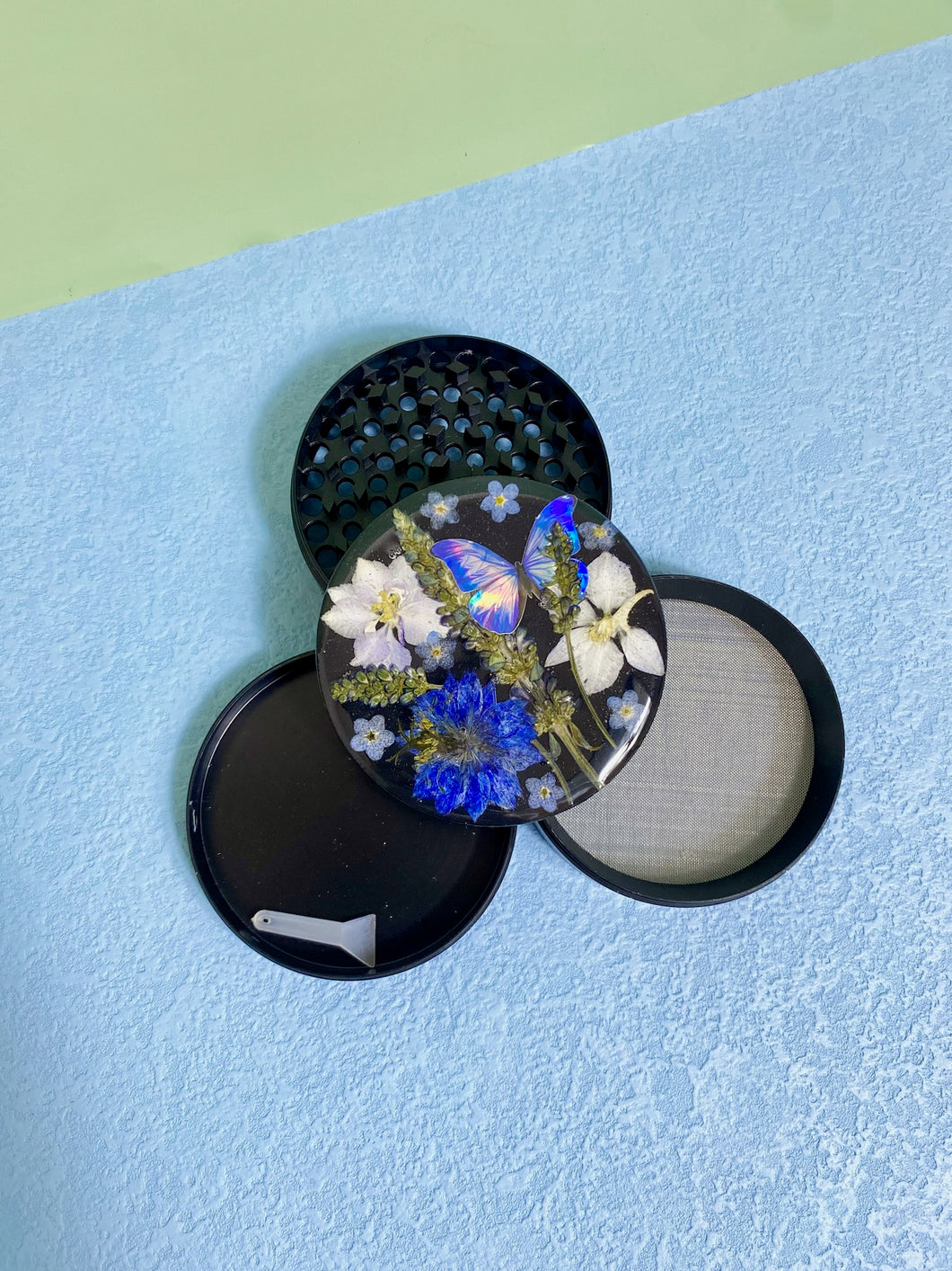 flower grinder with blue flowers and butterfly