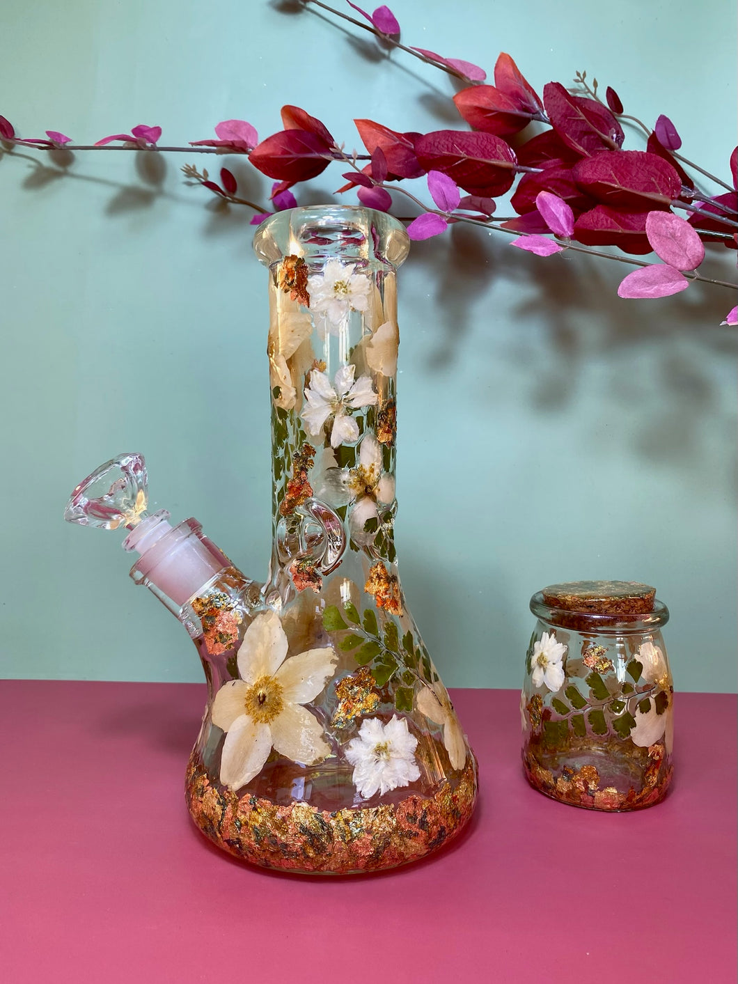 bong with white flowers and gold leaf