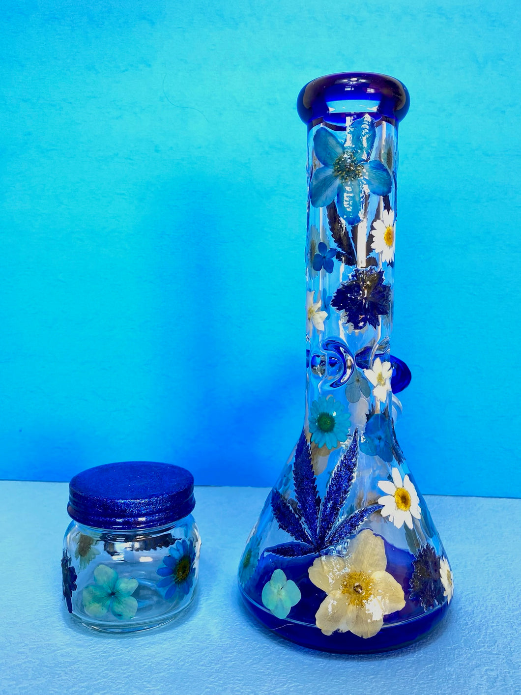 bong with blue accents and real flowers