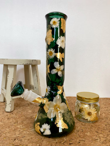 teal bong covered with real flowers