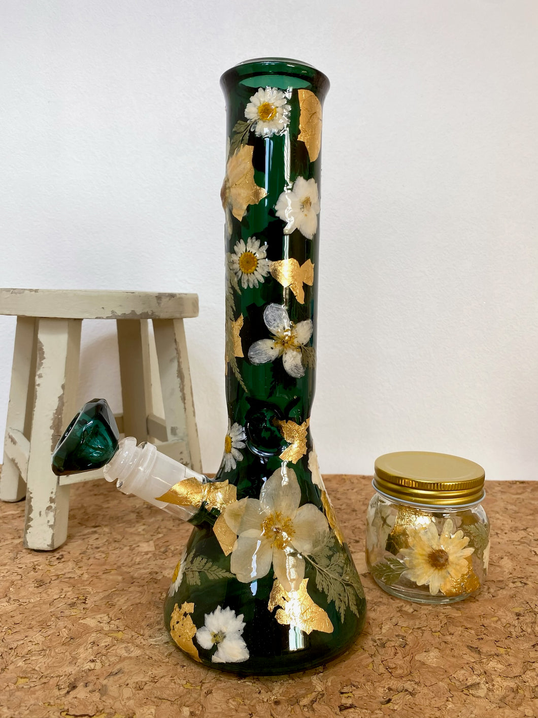 teal bong covered with real flowers